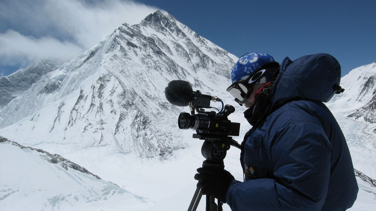Army on Everest, Everest West Ridge Expedition, cameraman on mountain, mount Everest in the background.