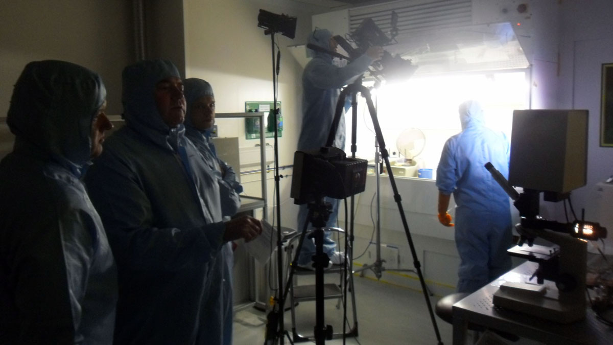 BAE Systems location filming crew dressed up in protective suits filming in a laboratory