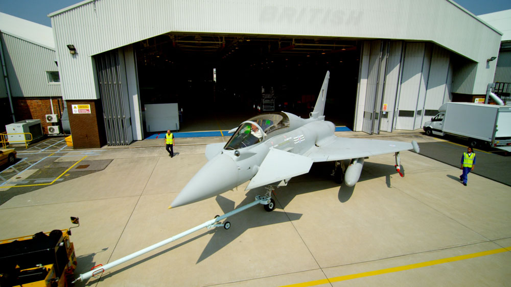 BAE Systems Innovation Technology Service video garage image, high camera view of a Typhoon jet coming out of a hangar, UK location