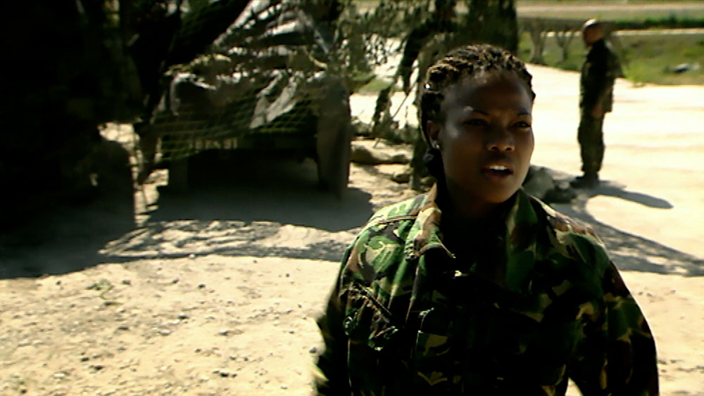 Army Jobs Be The Best, video garage image, young female soldier working in a desert location with camouflage vehicles behind, portrait of 1 of 140 army jobs for consideration