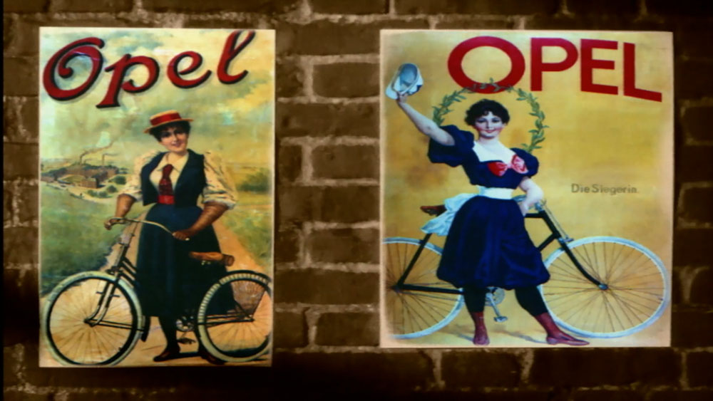 Adam Opel AG Brand Film, video garage image, historical marketing posters of Opel bicycles set against a brick wall in a motion control studio. Opel history recreated